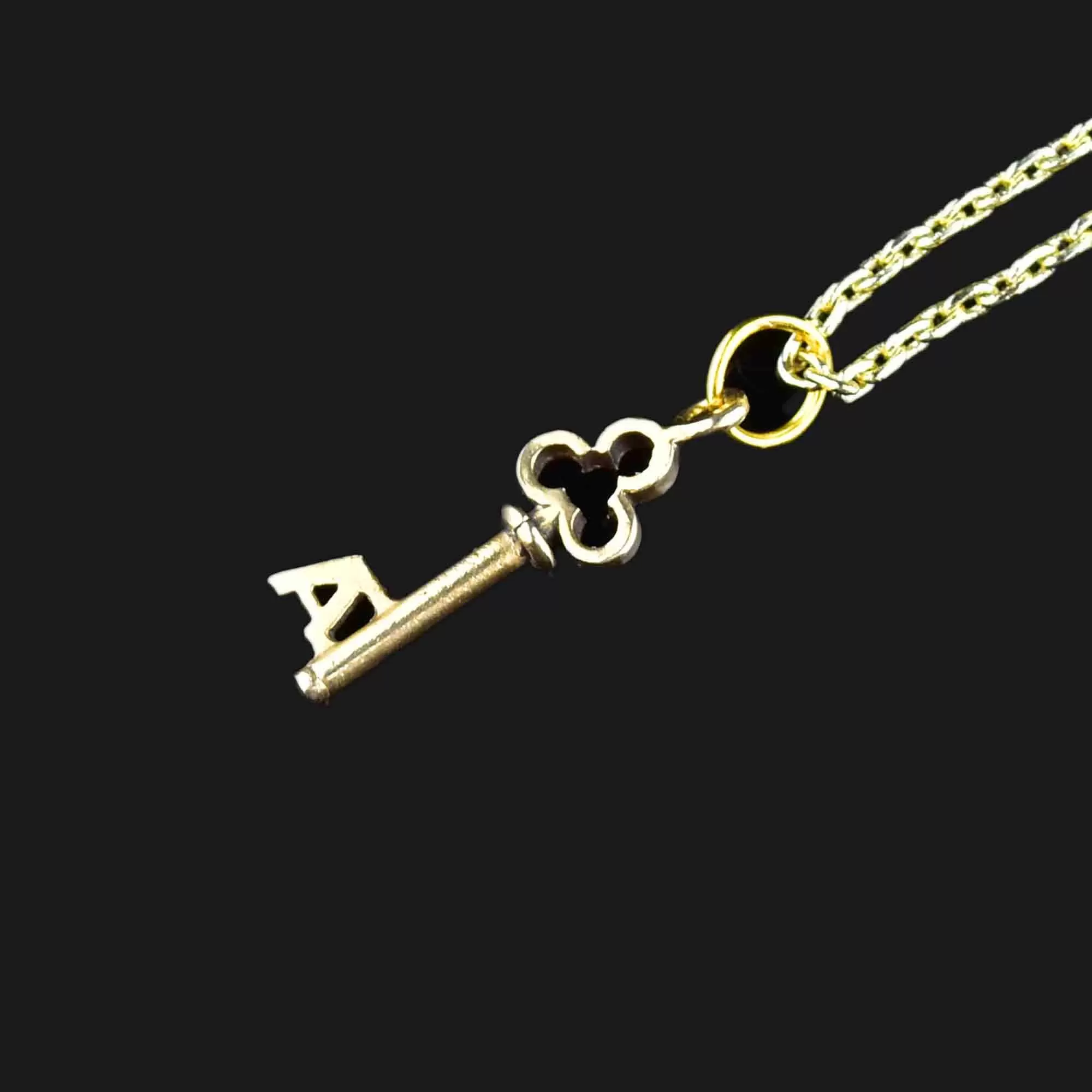 A Monogram Skeleton Key Necklace in 14K Gold